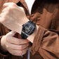 Man wearing an automatic hollow mechanical watch for men on wrist, showcasing its intricate design and elegance.
