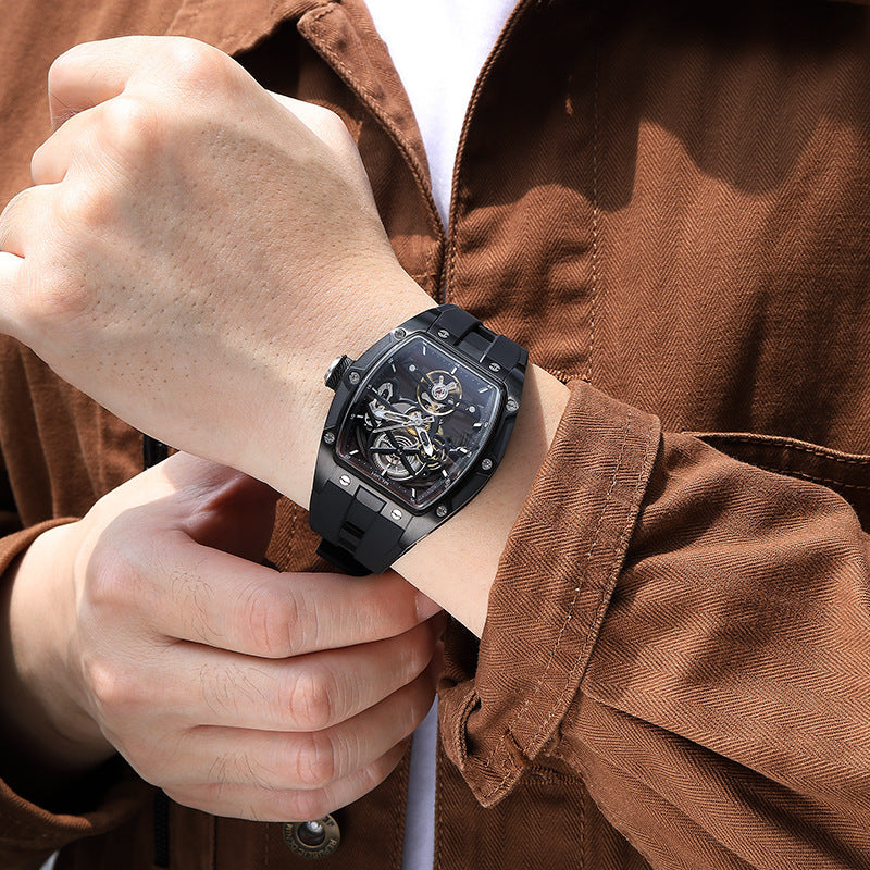 Man wearing an automatic hollow mechanical watch for men on wrist, showcasing its intricate design and elegance.