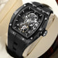 automatic hollow mechanical watch for men showcased on a soft cushion background in black and silver design.
